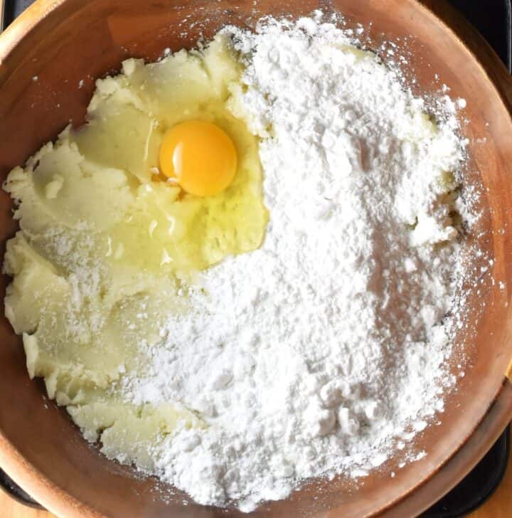 Mashed potato, flour and egg in wooden bowl.