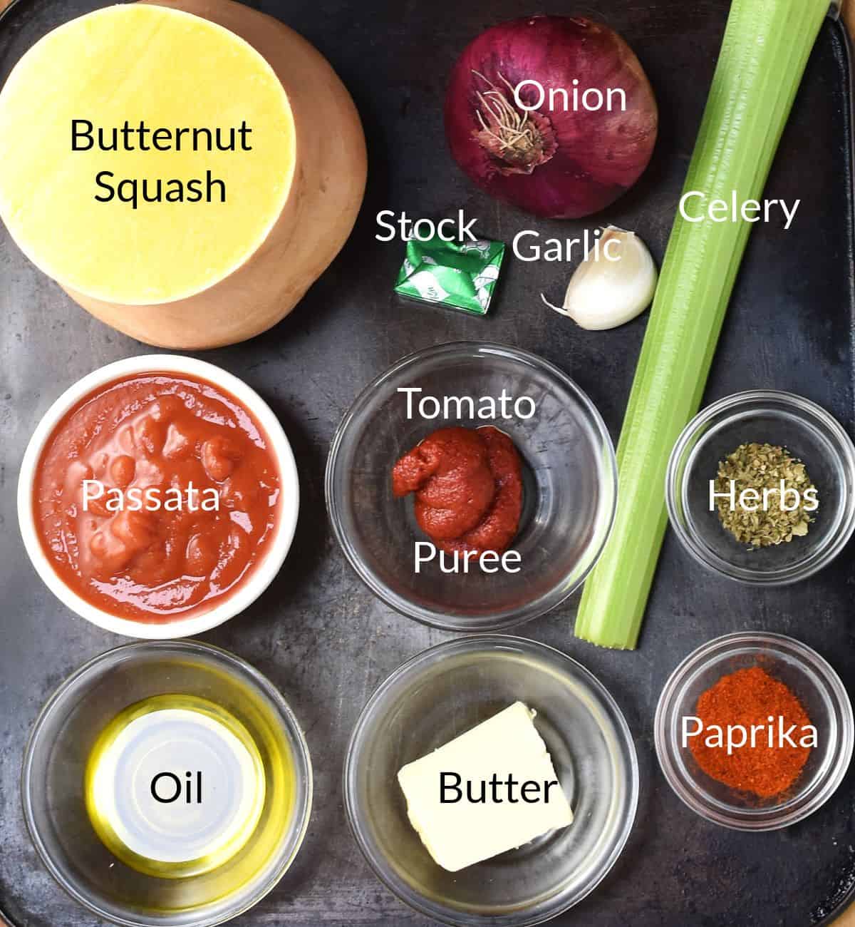 Ingredients for making butternut squash and tomato soup in individual dishes.