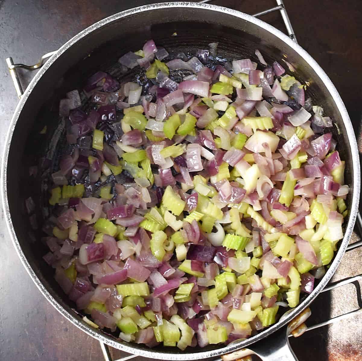Chopped celery and red onion in large pot.