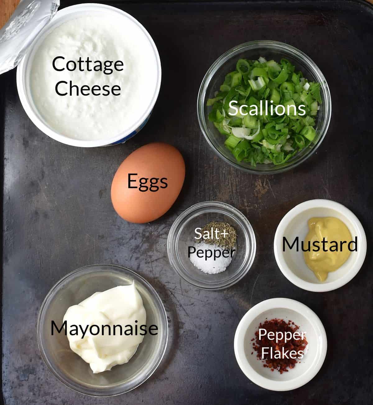 Ingredients for making egg cottage cheese salad in individual dishes.