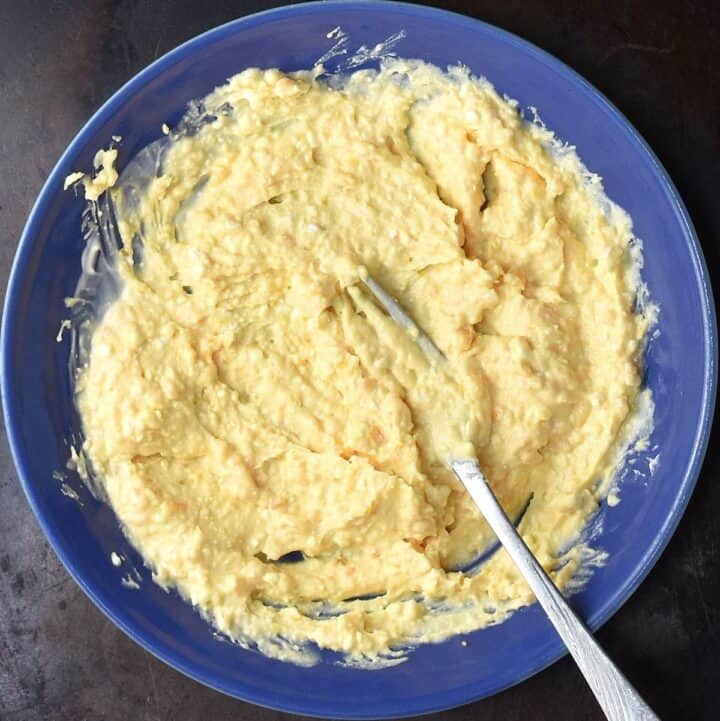 Creamy cottage cheese egg salad dressing in blue bowl with fork.