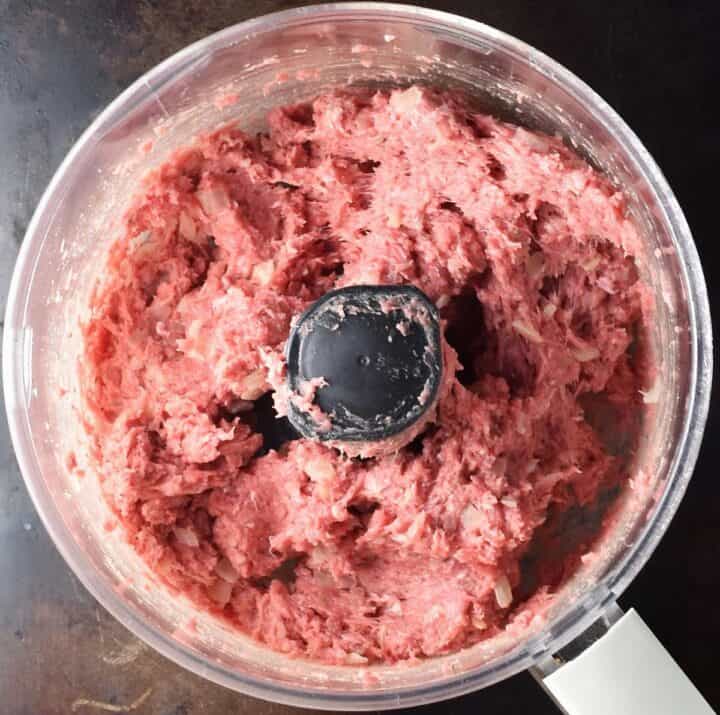 Top down view of koldunai filling mixture in food processor.