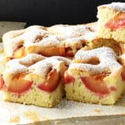 Side view of Polish plum cake squares on parchment.