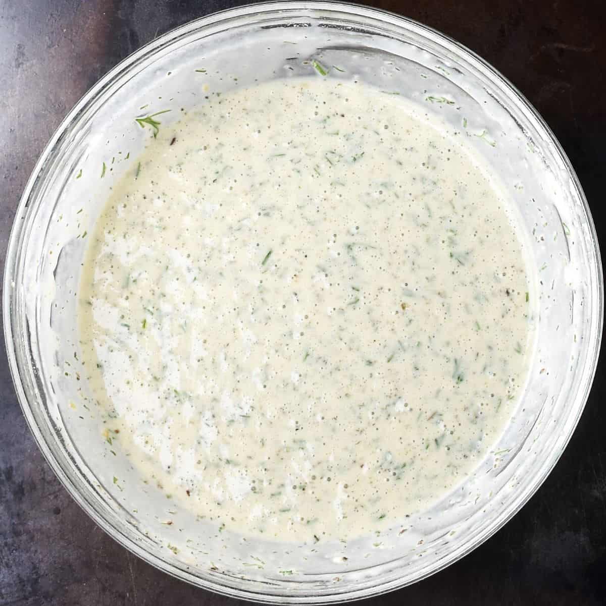 Top down view of sauerkraut pancake batter in glass bowl.