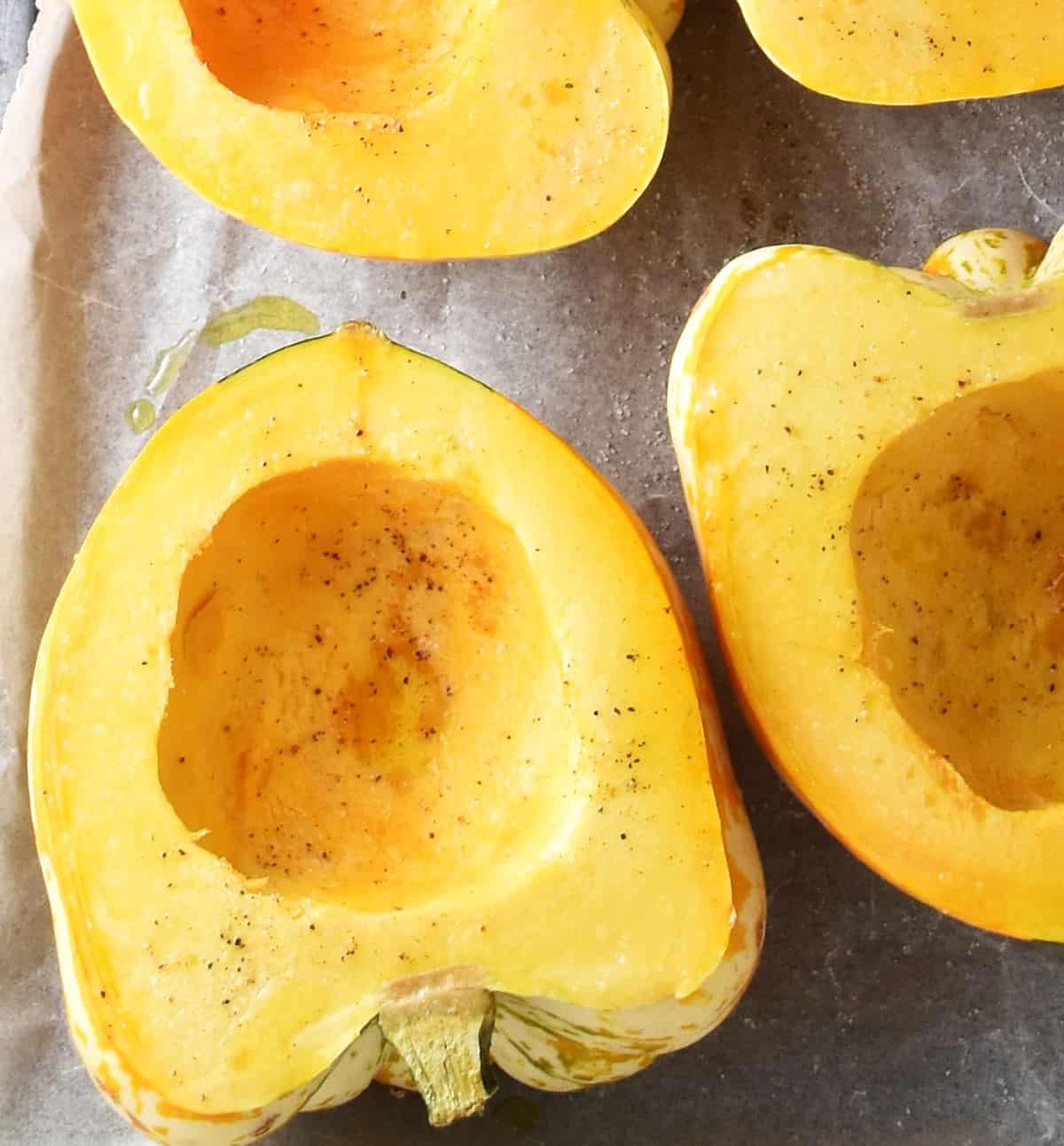 Top down view of halved and hollowed out acorn squash.