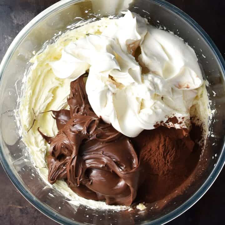 Chocolate spread, mascarpone and cocoa in glass bowl.