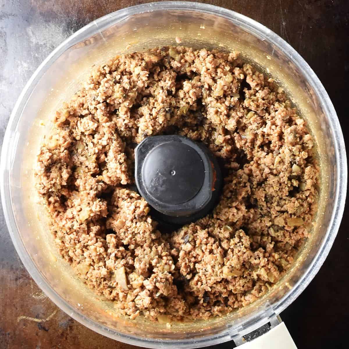 Stuffed potato patties filling in food processor bowl.