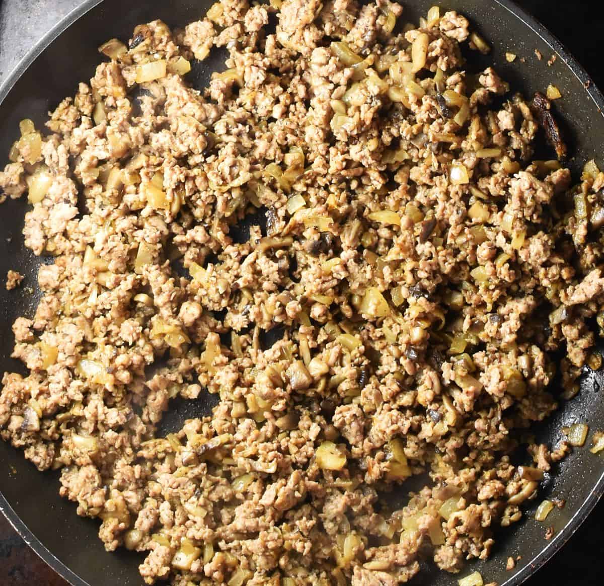 Ground meat filling mixture in large pan.