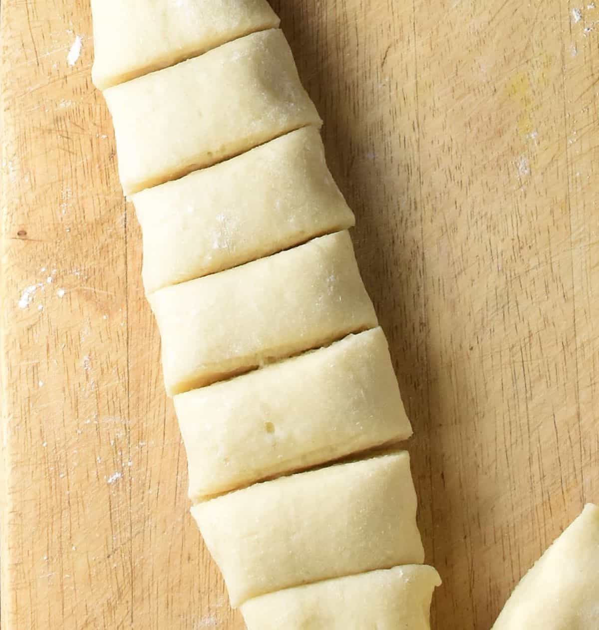 Potato dough log cut along width.