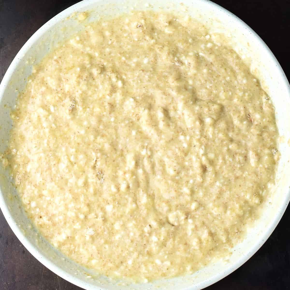 Cottage cheese banana pancake batter in large shallow bowl.