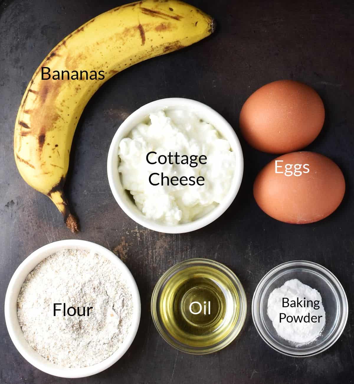 Ingredients for making cottage cheese and banana pancakes in individual dishes.
