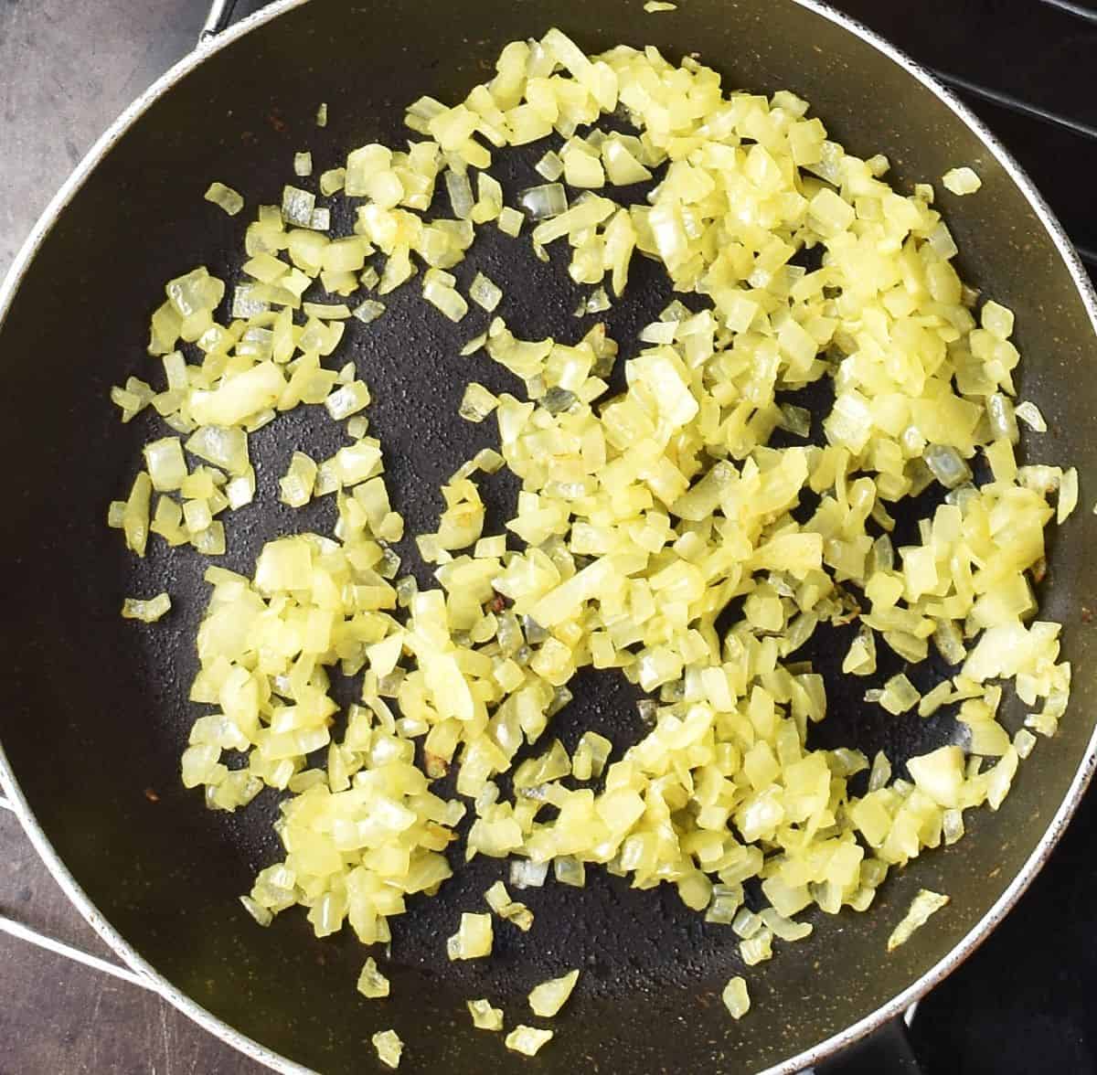Top down view of chopped onion in pan.
