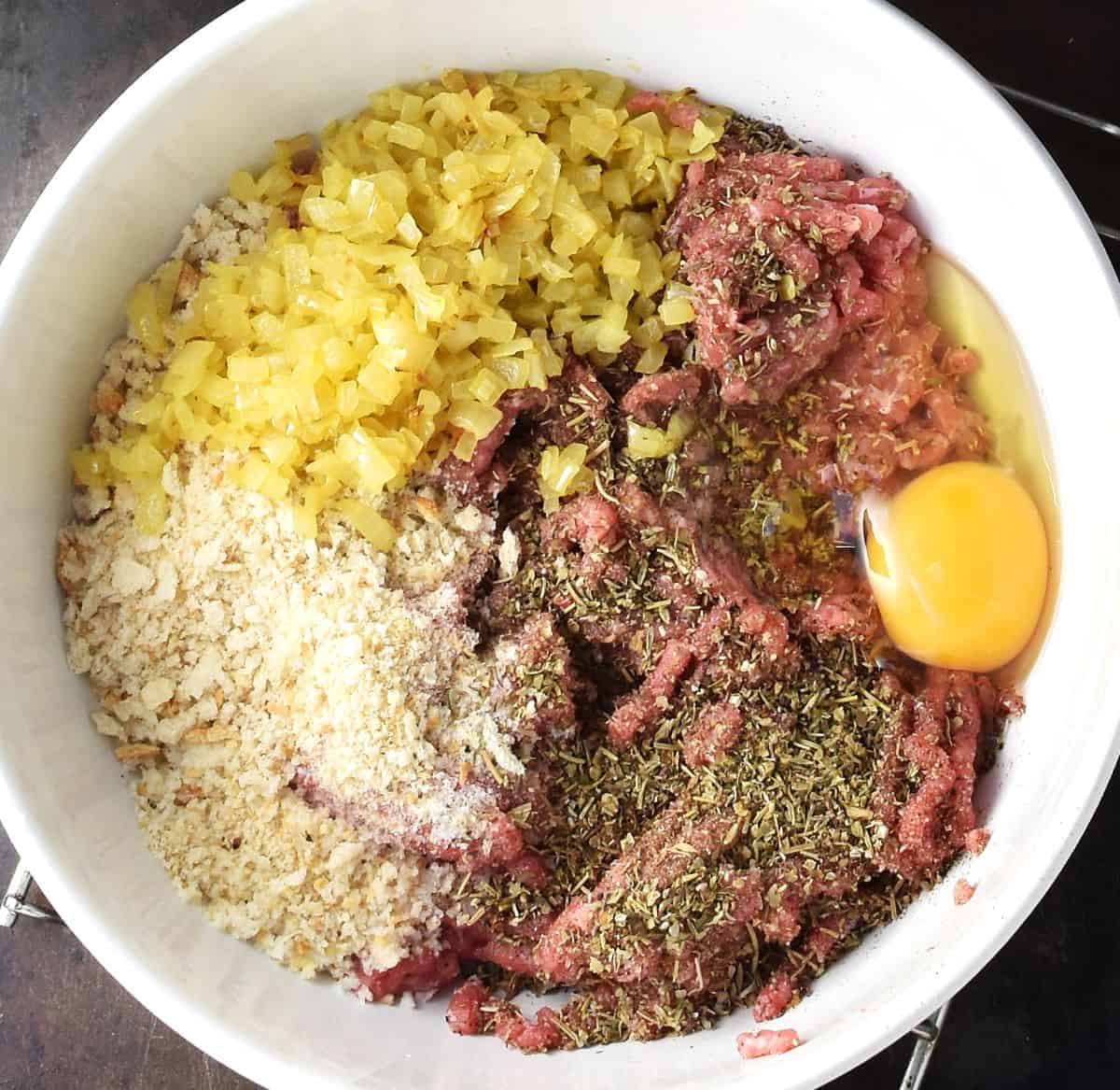 Top down view of turkey meatball ingredients in white bowl.