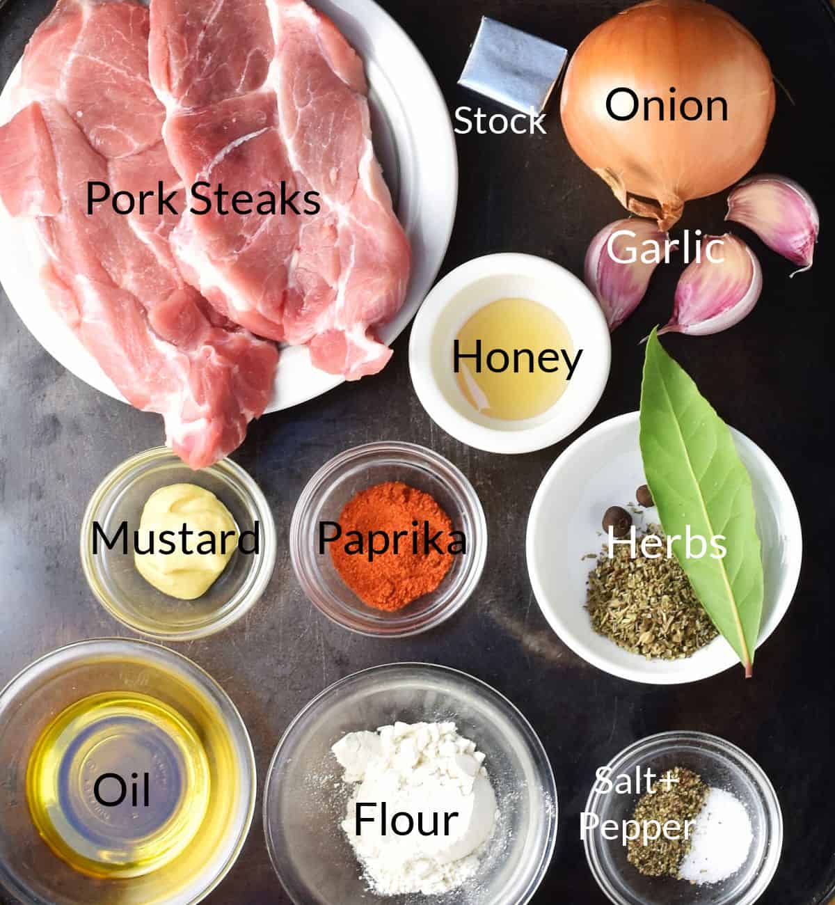 Top down view of ingredients for making braised pork steaks in individual dishes.