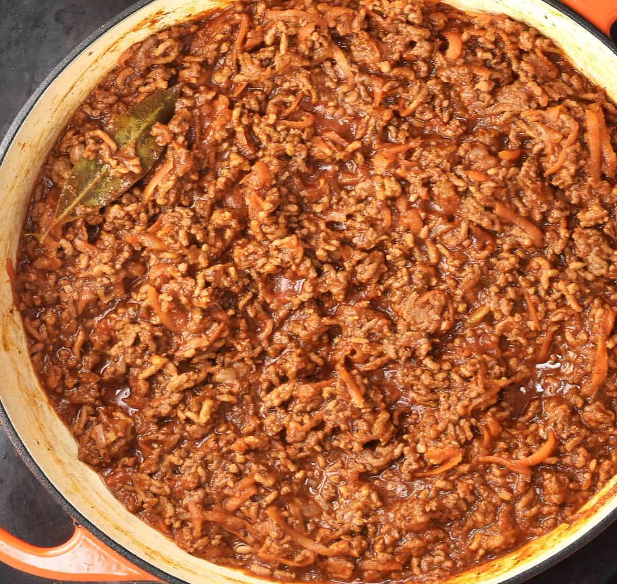 Top down view of potato lasagna filling mixture cooking in shallow pan.