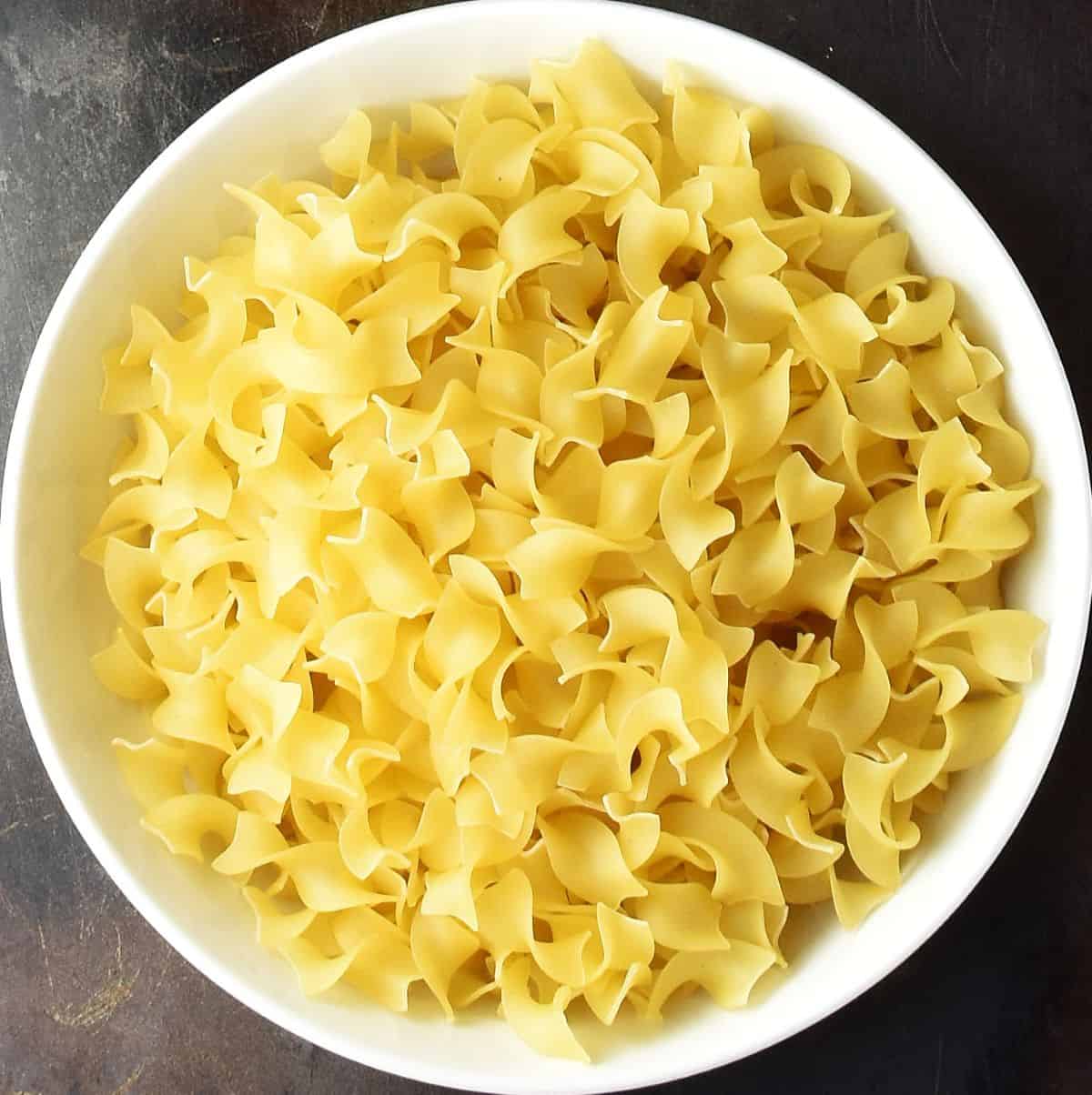 Top down view of Polish dried pasta in white bowl.