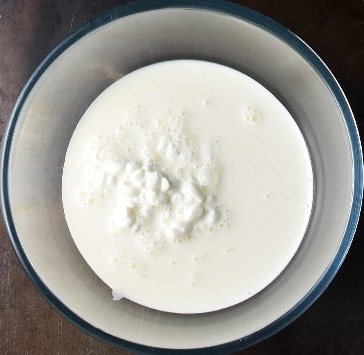 Cottage cheese and cream in glass bowl.