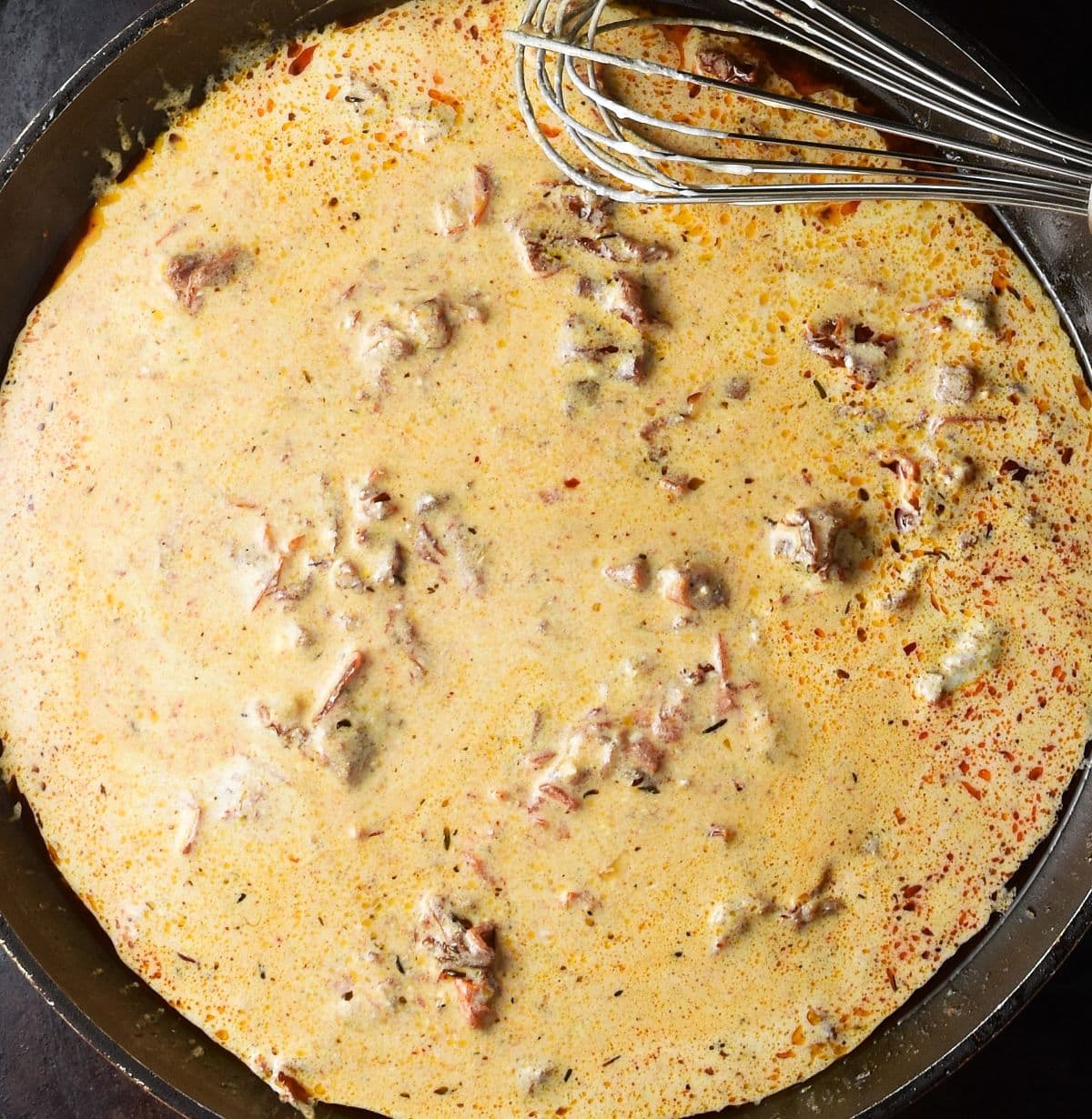 Creamy sundried tomato sauce for marry me chicken in skillet.