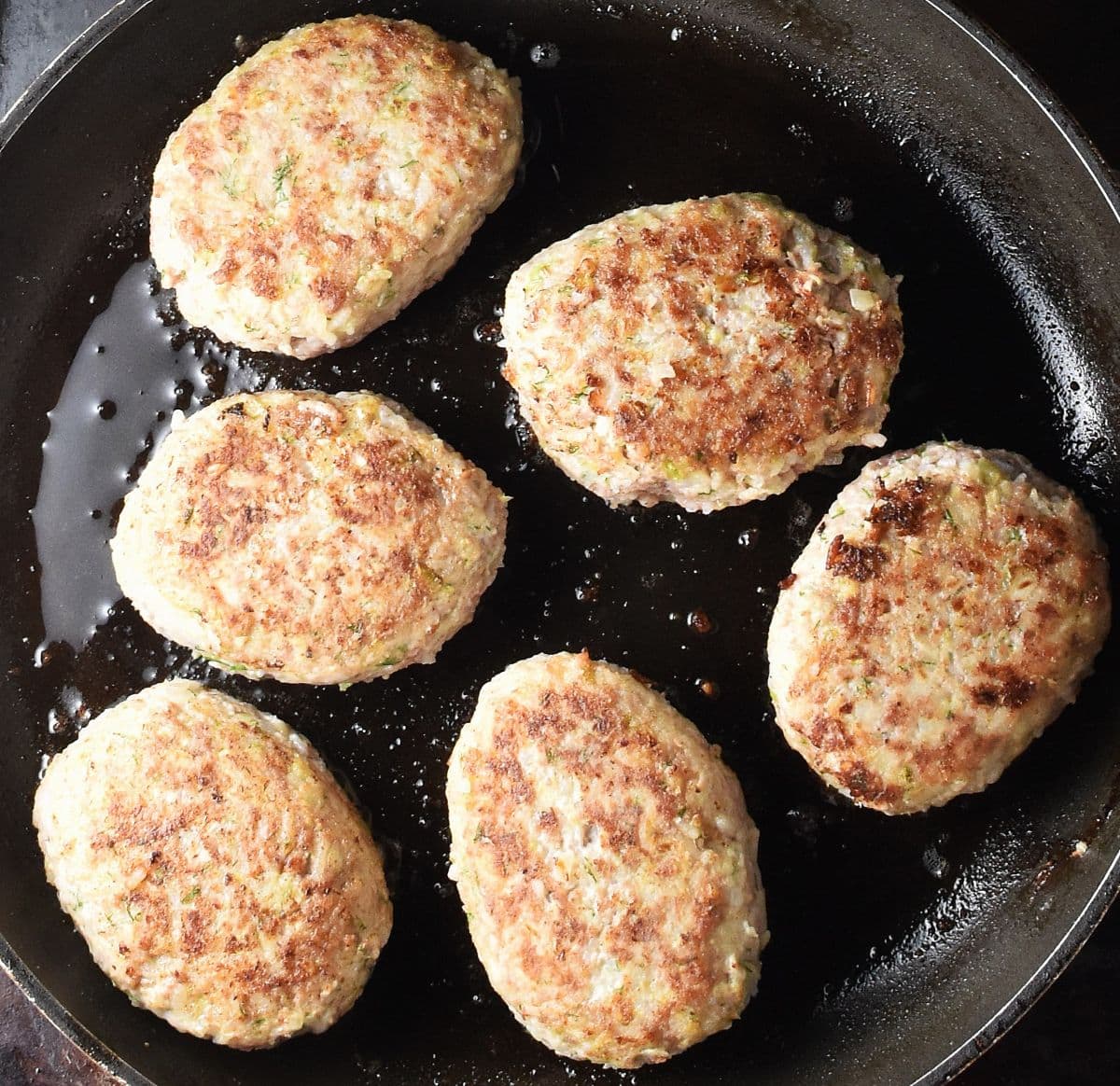 7 browned lazy cabbage rolls in large frying pan.