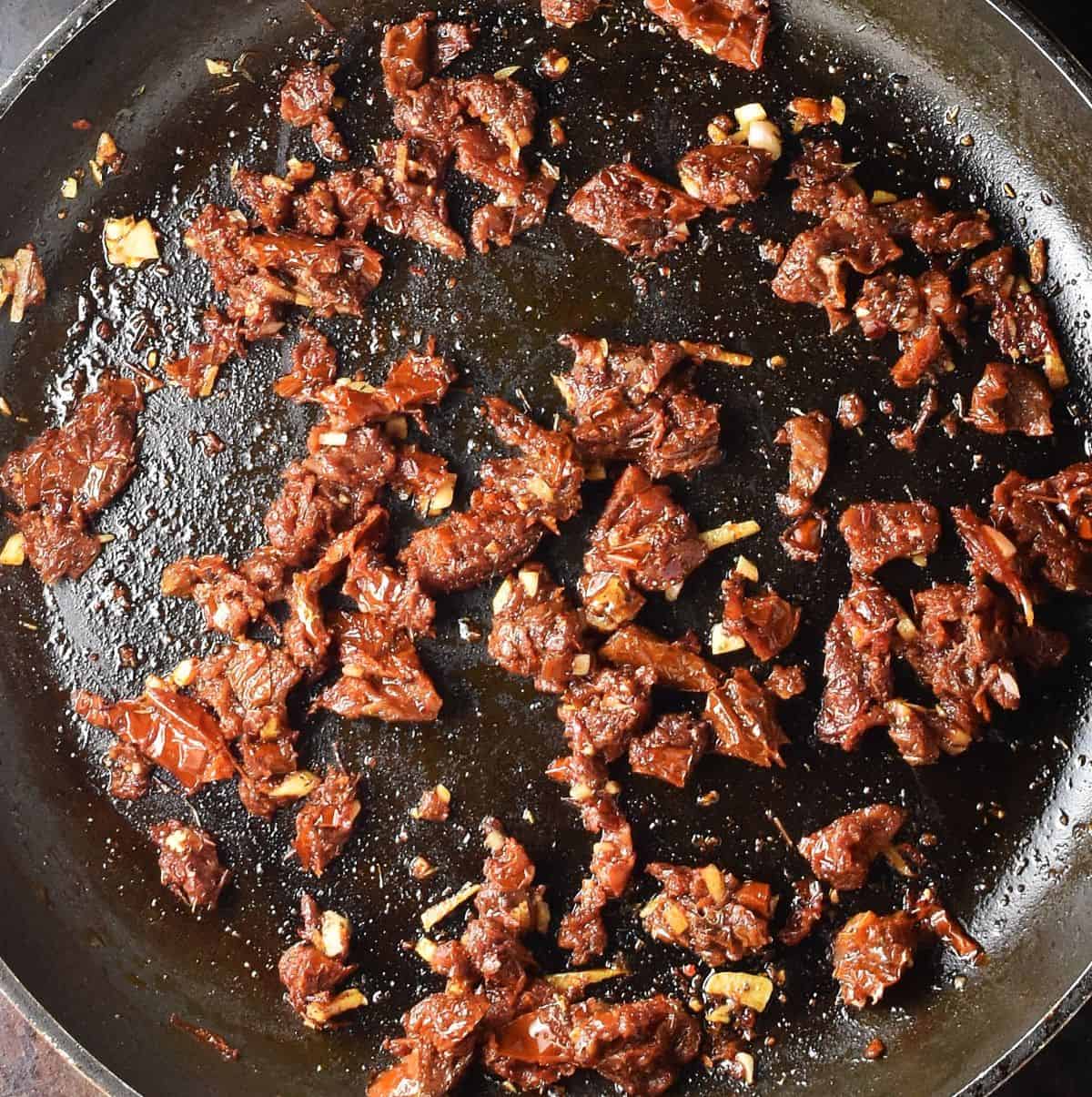 Chopped sundried tomatoes in large skillet.