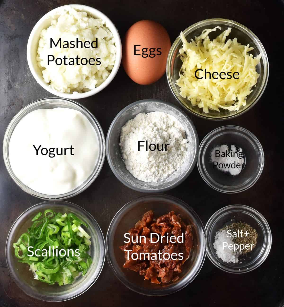 Top down view of ingredients for making potato and egg muffins in individual dishes with labels.