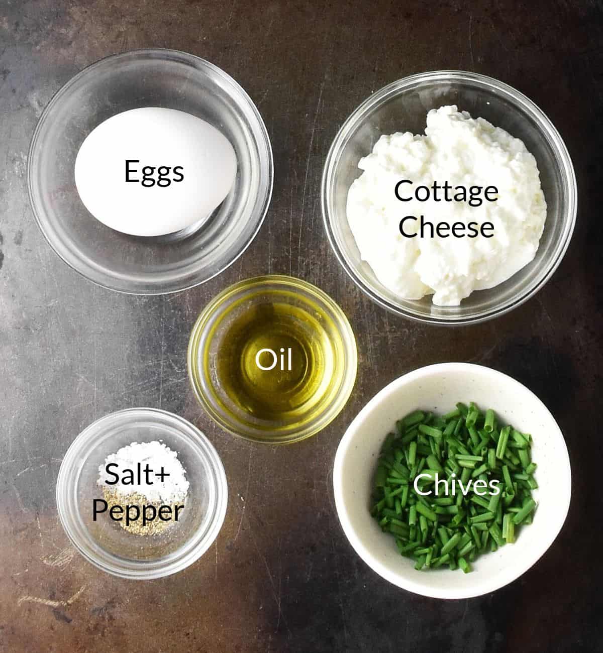 Top down view of ingredients for cottage cheese scrambled eggs in individual dishes.